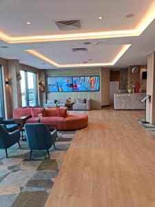 a large living room with red furniture and a flat screen tv at Bel Mare Aqua 2 F504 in Międzyzdroje
