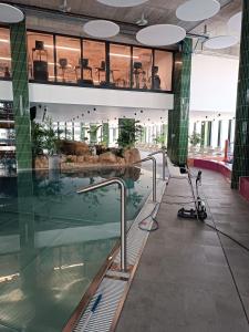 a large building with a swimming pool in the middle at Bel Mare Aqua 2 F504 in Międzyzdroje