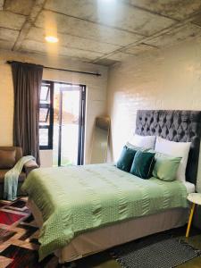 a bedroom with a large bed with blue pillows at Home at heart in Johannesburg