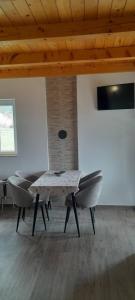 a dining room with a table and some chairs at MANN House in Ninkovići