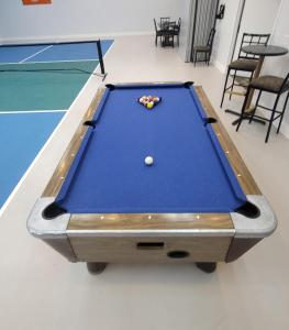 a pool table with a ball on top of it at Home Place Suites in Bartlesville