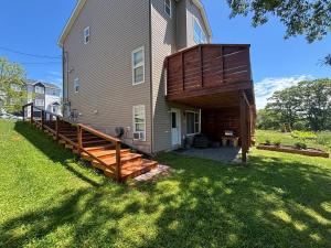 a house with a wooden deck on the side of it at Studio Guest Apartment in Dartmouth in Halifax