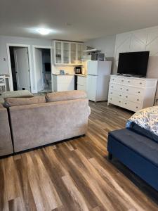 a living room with a couch and a kitchen at Studio Guest Apartment in Dartmouth in Halifax