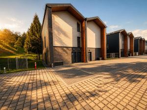 a building with a brick road in front of it at Vistula Apartment in Ustroń
