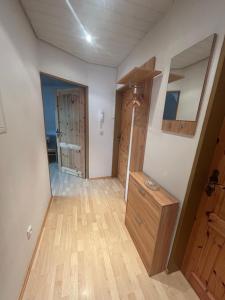 an empty room with a door and a wooden floor at Wohnung an der schönen Aue Stadtzentrumsnähe in Fulda