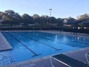 a large swimming pool with blue water at Prospect Haus Stone Oak in San Antonio