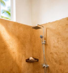 a shower in the corner of a room at Karibuni Marafiki in Bwejuu +66 photos