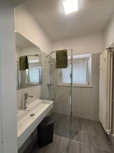 a white bathroom with a sink and a shower at Villa Renè in Tenno +20 photos