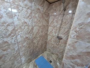 a bathroom with a shower with a blue stool at Casaluma in Jose De San Martin +11 photos