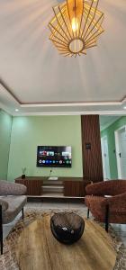 a living room with a flat screen tv on the wall at Mountain-Ridge Lux Stay in Rustenburg