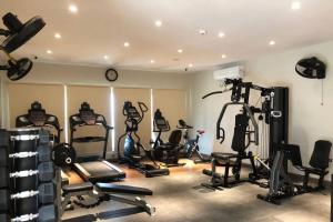 a gym with several exercise equipment in a room at 1 Bedroom Apartment at Centaurus Mall in Islamabad