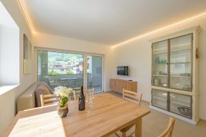 a dining room with a table and a couch at Ferienwohnungen Atz in Termeno
