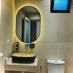 a bathroom with a sink and a mirror at Olive garden private Suite in Ksamil