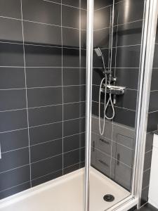 a shower with a glass door in a bathroom at Naturiste Cap d'Agde Héliopolis K 106 in Cap d'Agde