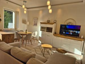 a living room with a couch and a tv and a table at DORMAR II Apartament in Wałbrzych +11 photos