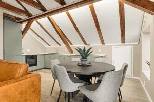 a kitchen and dining room with a table and chairs at 2026 New built Aparthotel - 5 units - 4BR - 2BR - SKB17 in Bergen