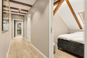 a bedroom with a bed and a hallway at 2026 New built Aparthotel - 5 units - 4BR - 2BR - SKB17 in Bergen
