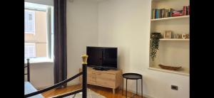 a living room with a television on a wooden dresser at Apartments San Rocco in Piran