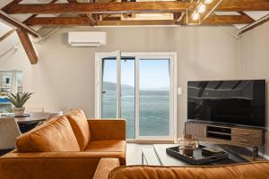 a living room with a couch and a large television at 2026 New built Aparthotel - 5 units - 4BR - 2BR - SKB17 in Bergen