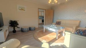a living room with a couch and a table at Haus Landlust - OG in Edersee +29 photos