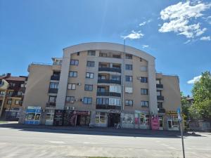 a large building on a street in front of a road at Apartman Dobrinja in Sarajevo