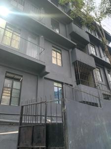 an apartment building with a gate in front of it at The 1802 backpackers hub in Shillong