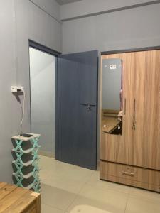 a room with a door and a phone next to a wall at The 1802 backpackers hub in Shillong
