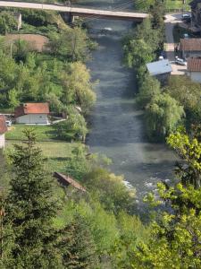 a river in a city with a bridge over it at Apartman Vrbas in Donji Vakuf