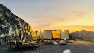 a house with a rock wall and tables and chairs at The Out Resort in Sinādil +21 photos