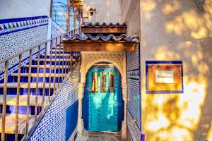 an entrance to a building with a blue door at XUQ Hotels Alaxara in Cubas