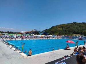 a large swimming pool with a lot of people in it at Apartments MIMOZA in Jagodina