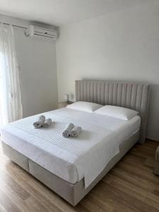 a bedroom with a bed with two towels on it at Sara Apartments in Makarska