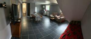 a view of a living room with a table and chairs at Mady in Villeneuve-sur-Lot
