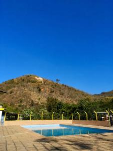 a swimming pool with a mountain in the background at Pousada Quinta de Areal in Areal +16 photos