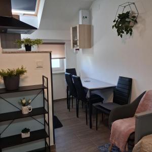 a dining room with a table and chairs at Studio apartmani Atlantik in Nedelišće +9 photos