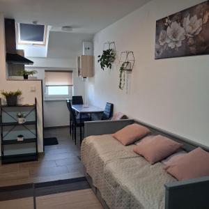 a bedroom with a bed and a table in a room at Studio apartmani Atlantik in Nedelišće