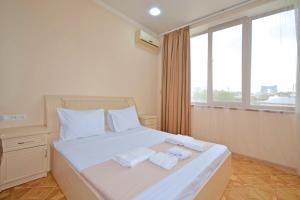 a bedroom with a bed with two towels on it at Soma Apart-hotel in Center in Yerevan