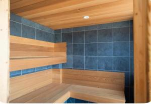a room with wooden shelves and blue tiles at Double room container in Berkley
