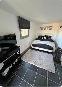 a bedroom with a bed and a piano at Double room container in Berkley