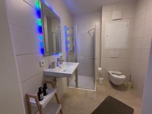 a white bathroom with a sink and a toilet at Donau Vibes Luxury Family near City and Highway in Linz +28 photos