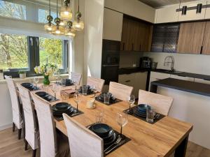 a dining room with a wooden table and chairs at Dom Port Orion Puck in Puck