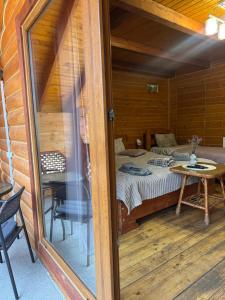 a room with a bed and a table and a window at Готель Близнюки in Vorokhta