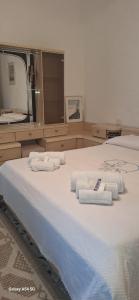 a bedroom with a large bed with towels on it at B&B Sa Rocca Manna in Laerru