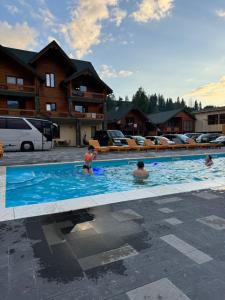a group of people in a swimming pool at Готель Близнюки in Vorokhta