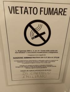 a sign with a no smoking sign on a wall at Sole Luna B&B in Pescara