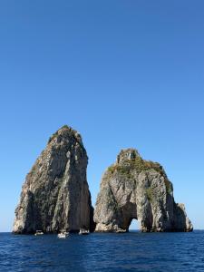 an island in the ocean with boats in it at Villa Sain Charming Suite in Anacapri