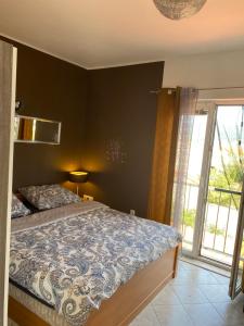 a bedroom with a bed and a large window at Botic Apartments in Šilo