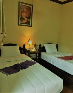 Tempat tidur dalam kamar di BKC villa