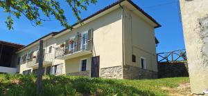 a large white building with two balconies at La Paulotta in Paroldo