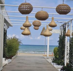 a row of lights hanging over a walkway to the beach at Casa Cleo in Tortoreto Lido